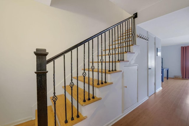 stairs with hardwood / wood-style floors