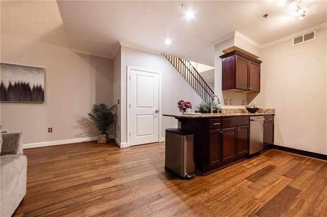 bar featuring hardwood / wood-style flooring, dishwasher, dark brown cabinets, and ornamental molding