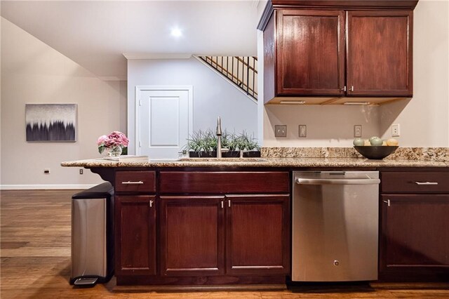 bar with dishwasher, light stone counters, sink, and light hardwood / wood-style flooring