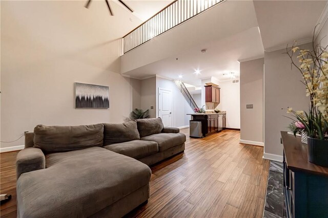 living room with light hardwood / wood-style floors and ornamental molding