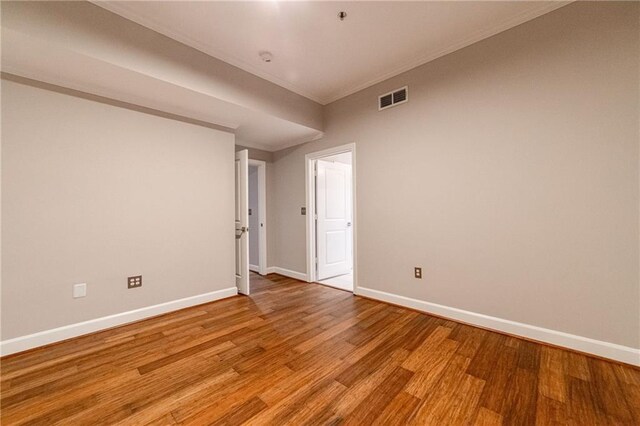 unfurnished room featuring crown molding and light hardwood / wood-style flooring