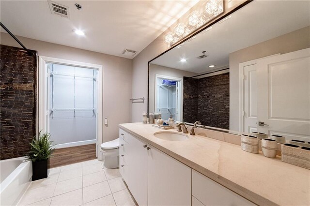 full bathroom with bathing tub / shower combination, hardwood / wood-style floors, vanity, and toilet