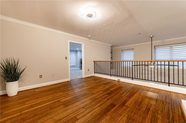 spare room with crown molding and hardwood / wood-style floors