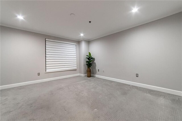 unfurnished room featuring carpet and ornamental molding