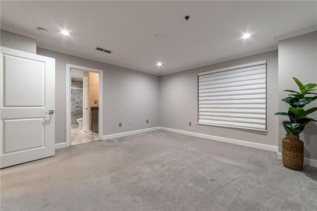 carpeted bedroom featuring ensuite bath