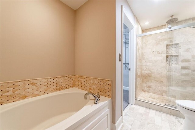 bathroom with tile patterned floors, plus walk in shower, and toilet