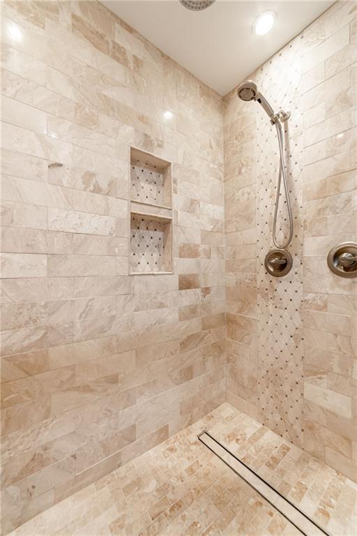 bathroom with a tile shower