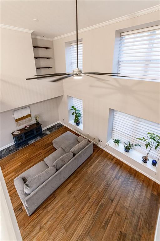 living room featuring hardwood / wood-style floors and crown molding