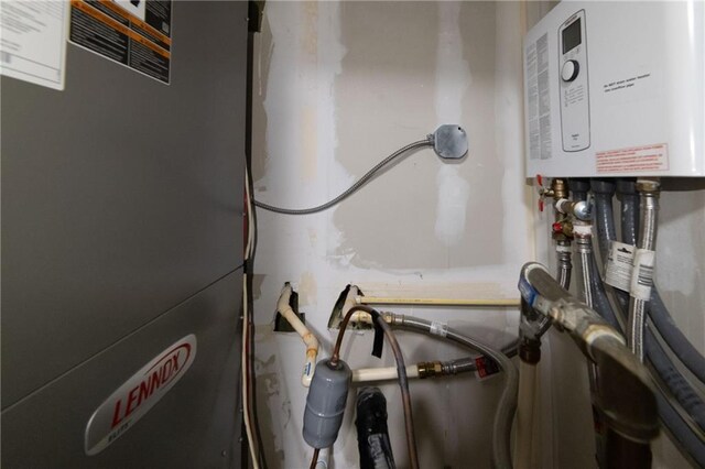 utility room featuring tankless water heater