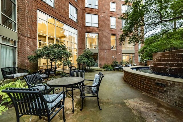 view of patio / terrace featuring pool water feature