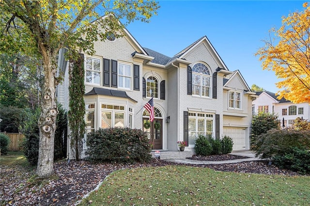 view of front of property with a garage and a front yard