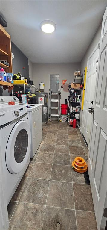112 Hilltop Dr, Newborn, GA 30056 - laundry room featuring stone tile floors, independent washer and dryer, water heater, and electric panel