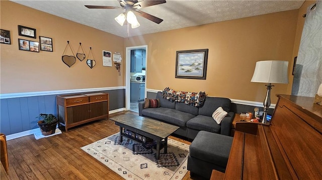 112 Hilltop Dr, Newborn, GA 30056 - living room with wood finished floors, ceiling fan, a wainscoted wall, and a textured ceiling