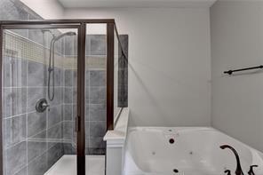 1668 Sabastian Pt NE, Atlanta, GA 30329 - bathroom with a jetted tub and a stall shower