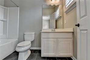 1668 Sabastian Pt NE, Atlanta, GA 30329 - bathroom with shower / bathing tub combination, tile patterned floors, baseboards, vanity, and toilet