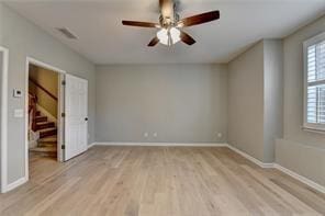 1668 Sabastian Pt NE, Atlanta, GA 30329 - unfurnished room with visible vents, wood finished floors, baseboards, ceiling fan, and stairway