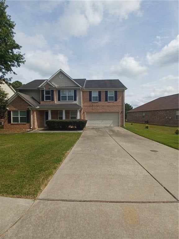 view of front facade with a front yard and a garage