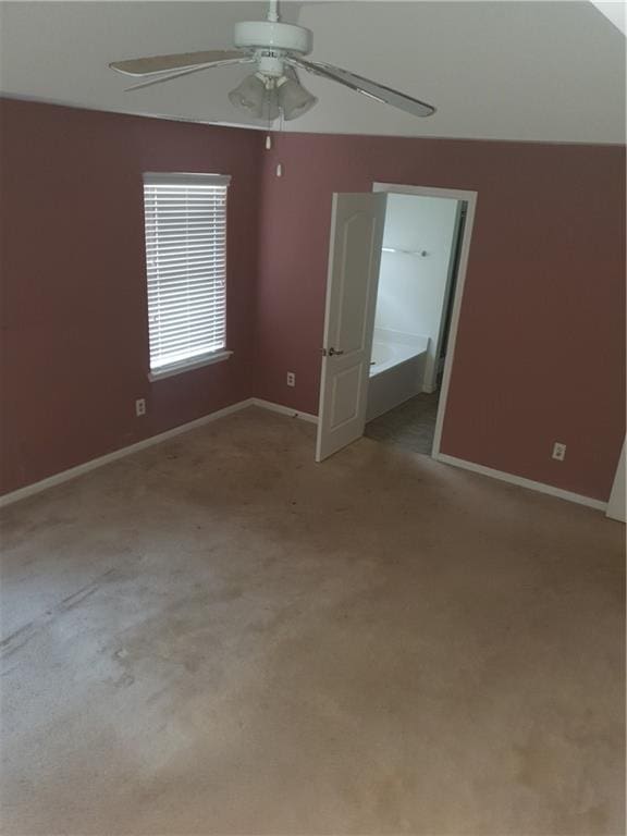 spare room featuring ceiling fan and light carpet