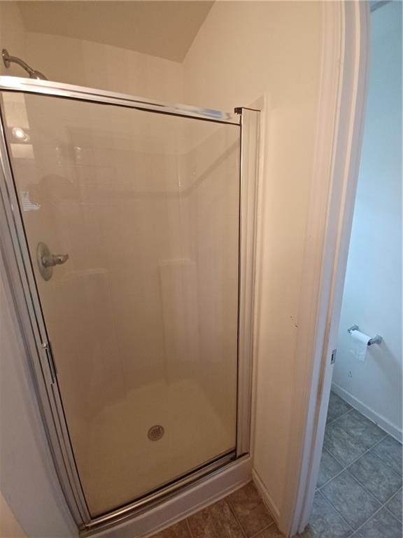 bathroom with tile patterned flooring and an enclosed shower