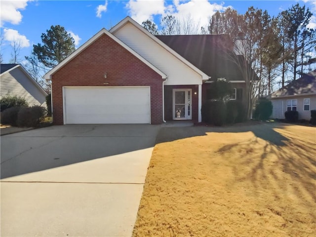 view of front of home with an attached garage, driveway, and brick siding