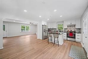 440 Colbert Rd, Dallas, GA 30132 - kitchen featuring appliances with stainless steel finishes, open floor plan, healthy amount of natural light, a breakfast bar area, and recessed lighting
