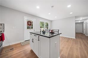 440 Colbert Rd, Dallas, GA 30132 - kitchen featuring dark countertops, light wood finished floors, baseboards, a center island, and recessed lighting