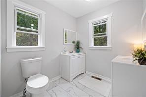 440 Colbert Rd, Dallas, GA 30132 - bathroom featuring vanity, toilet, baseboards, and marble finish floors