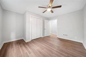 440 Colbert Rd, Dallas, GA 30132 - unfurnished bedroom featuring baseboards, wood finished floors, a closet, and ceiling fan