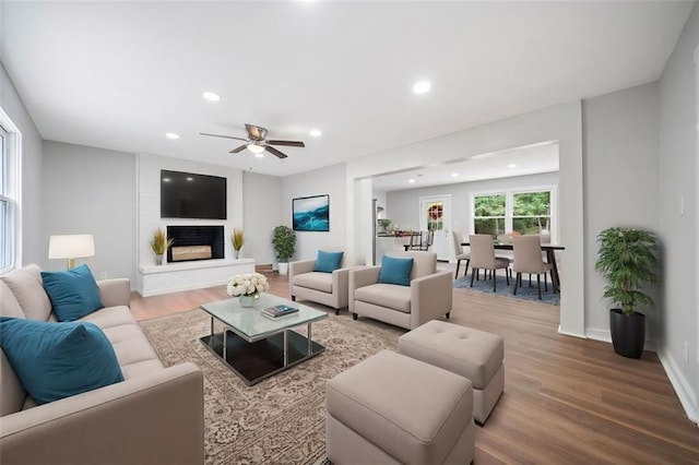 440 Colbert Rd, Dallas, GA 30132 - living area featuring wood finished floors, ceiling fan, recessed lighting, a fireplace with raised hearth, and baseboards