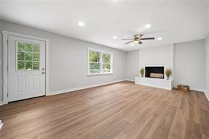 440 Colbert Rd, Dallas, GA 30132 - unfurnished living room with a fireplace with raised hearth, wood finished floors, recessed lighting, baseboards, and ceiling fan