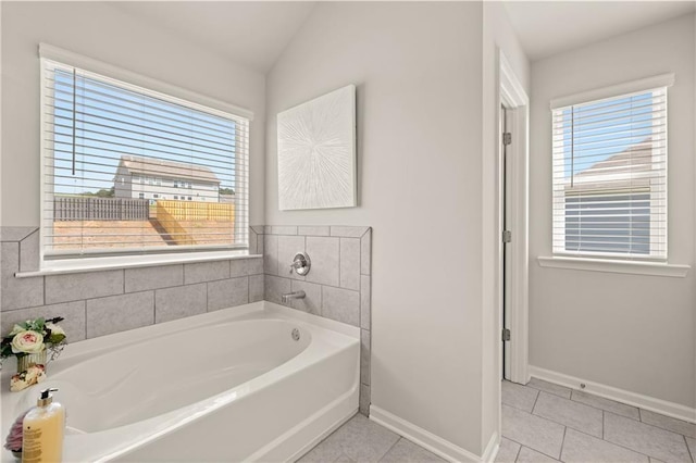 1054 Georgian Point Dr, Lawrenceville, GA 30045 - bathroom featuring a wealth of natural light, tile patterned flooring, baseboards, and a garden tub