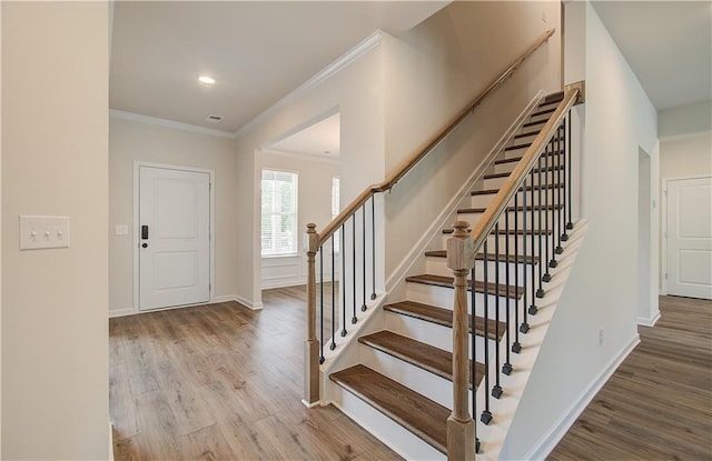 1054 Georgian Point Dr, Lawrenceville, GA 30045 - staircase with visible vents, baseboards, ornamental molding, and wood finished floors