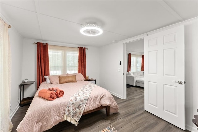 bedroom with baseboards and wood finished floors