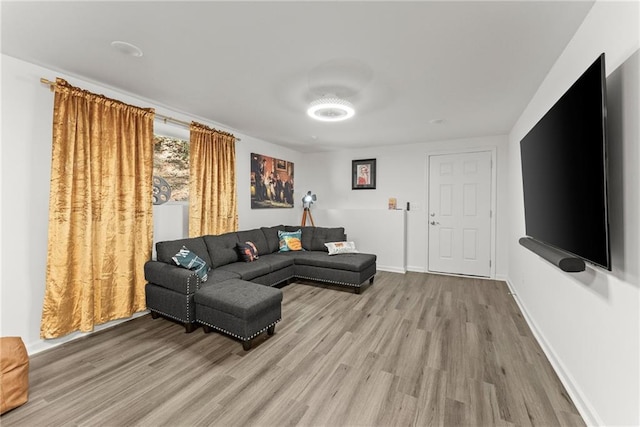 living area with light wood-style floors and baseboards