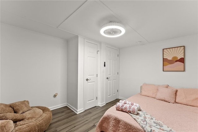 bedroom featuring wood finished floors and baseboards