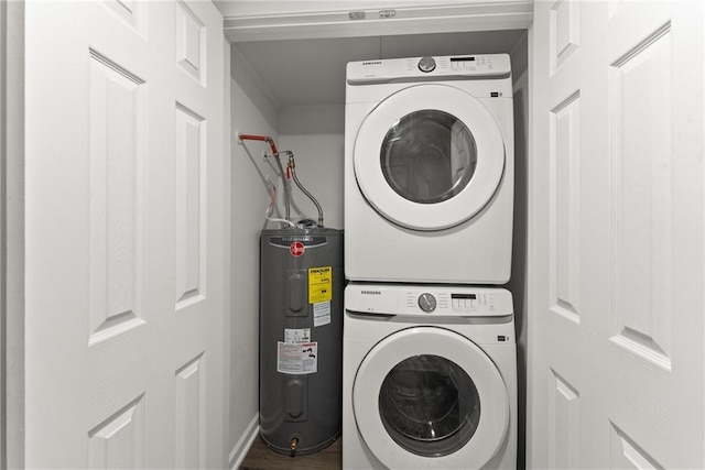 washroom with laundry area, stacked washer and dryer, and electric water heater