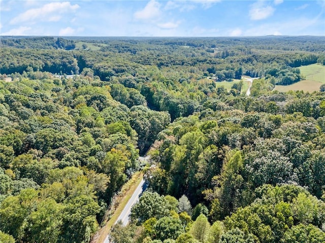 birds eye view of property with a wooded view