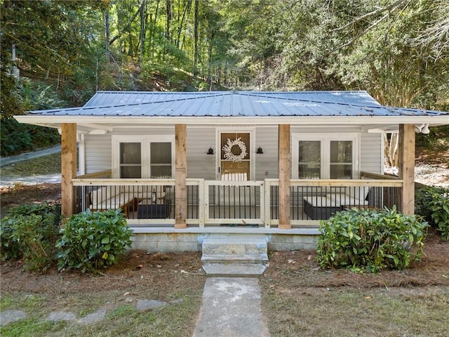 bungalow-style house with covered porch and metal roof