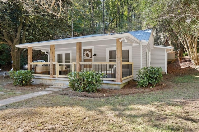 view of front of home featuring metal roof and a porch