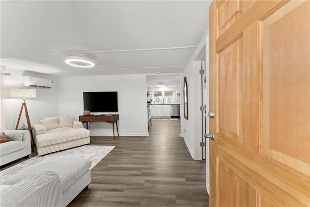 living room with baseboards, dark wood-type flooring, and an AC wall unit