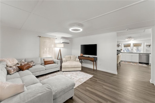 living area featuring baseboards and wood finished floors