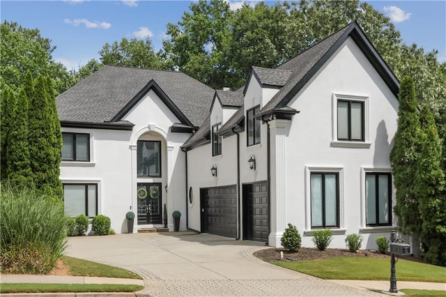 french country style house featuring a garage