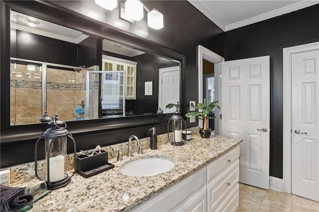 bathroom with tile patterned floors, vanity, an enclosed shower, and ornamental molding