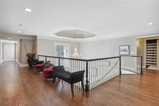 hallway featuring crown molding, hardwood / wood-style floors, and a chandelier