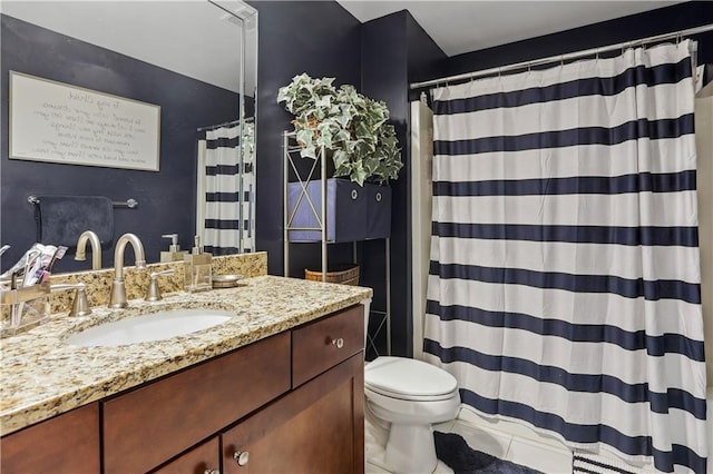 bathroom featuring toilet, vanity, and tile patterned floors