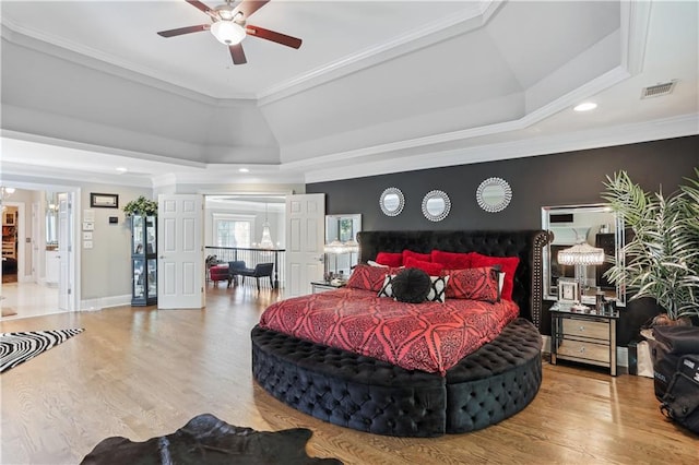 bedroom featuring wood-type flooring, ceiling fan, and crown molding