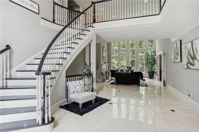 staircase featuring tile patterned flooring and a towering ceiling