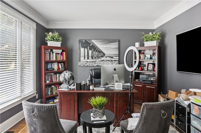 office area with plenty of natural light, crown molding, and light hardwood / wood-style flooring