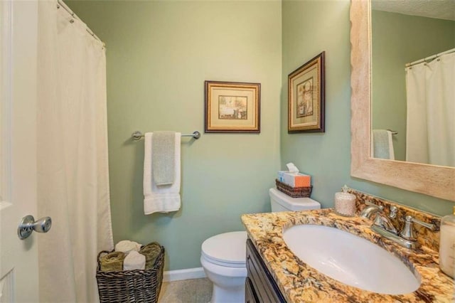 bathroom with tile patterned flooring, toilet, and vanity