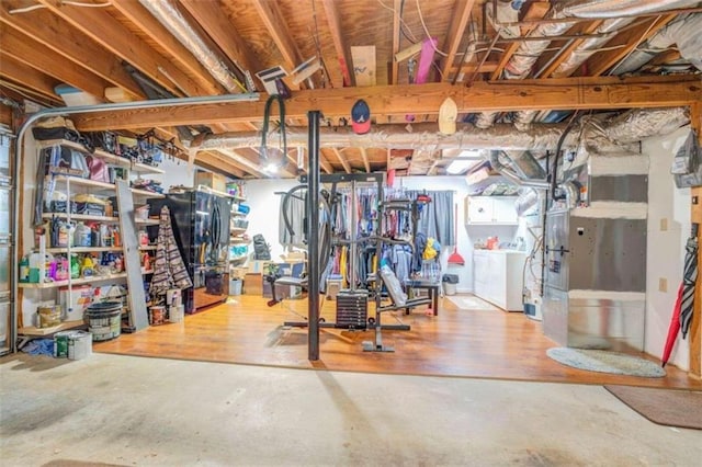 basement featuring washer / dryer and wood-type flooring